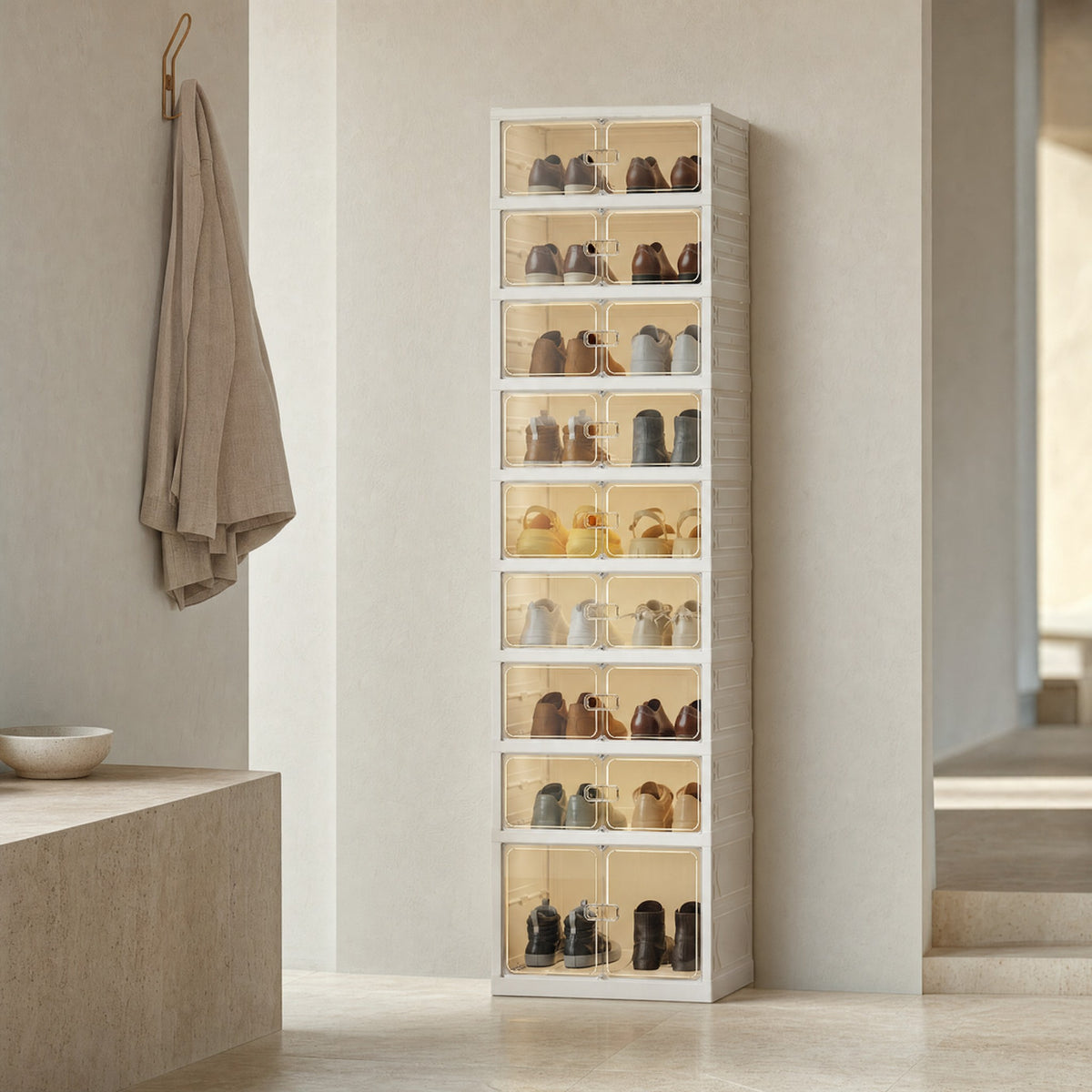 Beige 9-layer foldable shoe cabinet with clear doors standing in an ivory entryway with a travertine floor