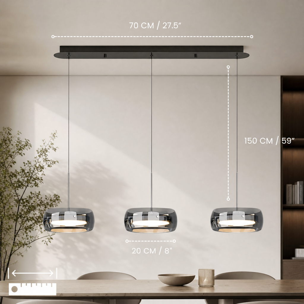 Glass drum pendant light hanging above a kitchen island