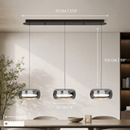 Glass drum pendant light hanging above a kitchen island