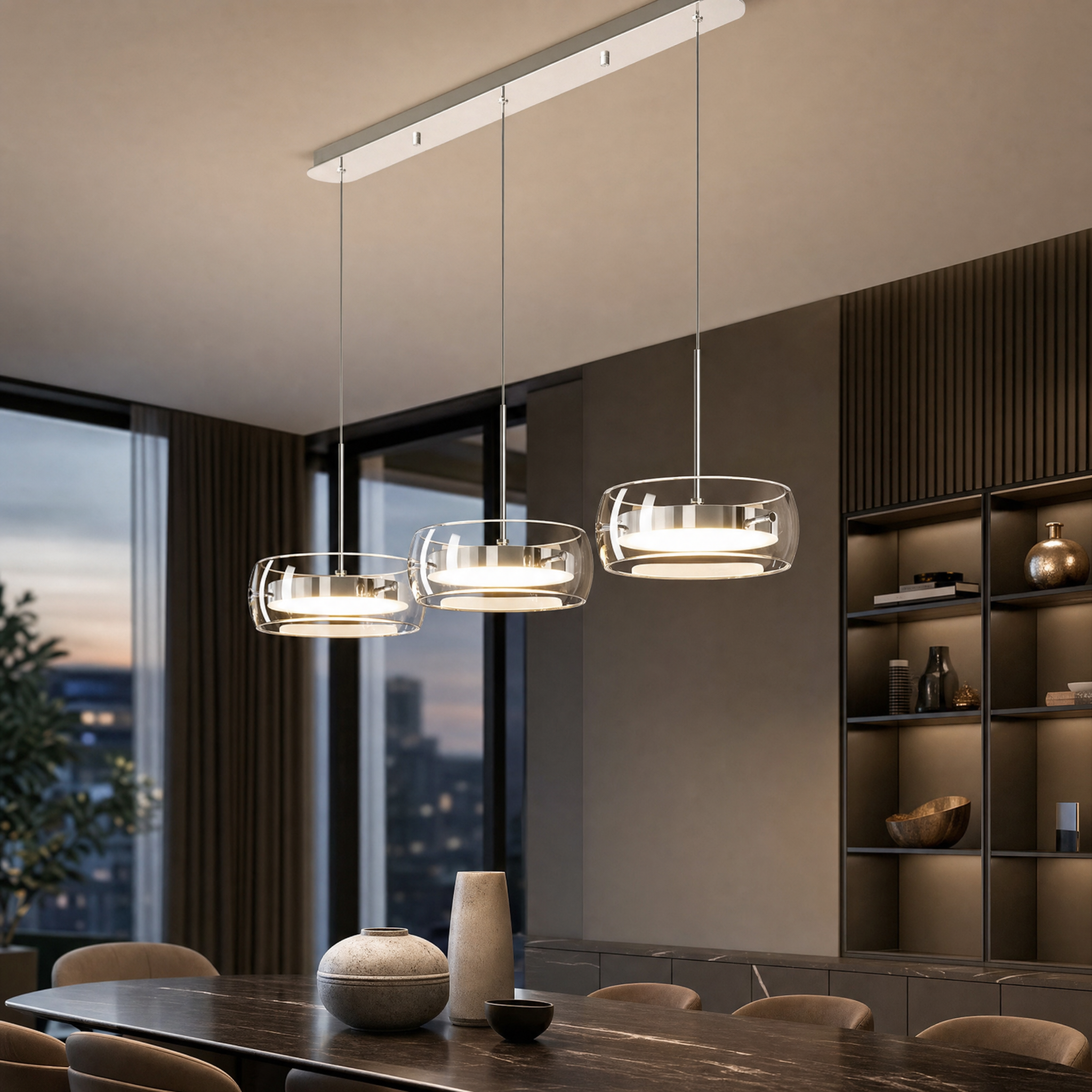 Three-head glass drum pendant light over a dining table