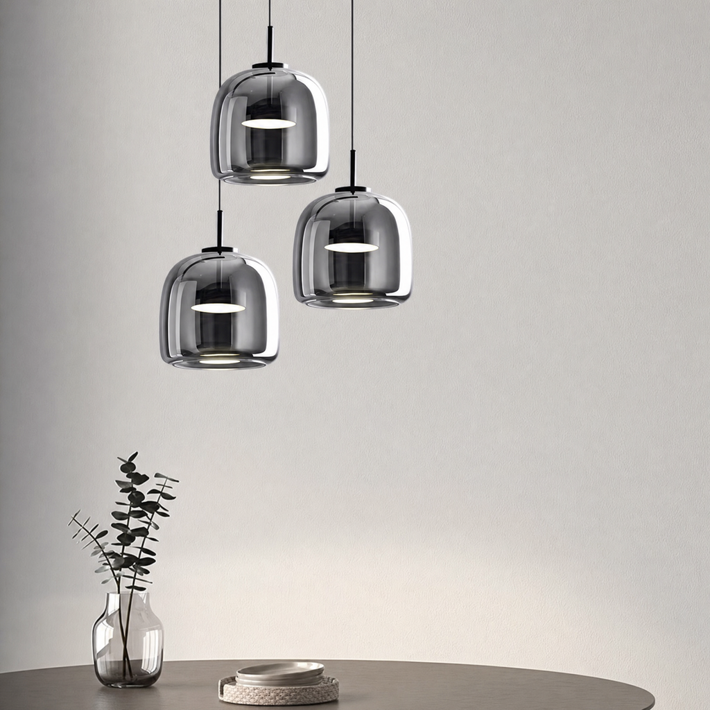 Moon glass pendant light set to cool white over a dining table