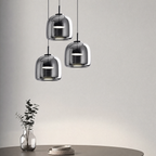 Moon glass pendant light set to cool white over a dining table