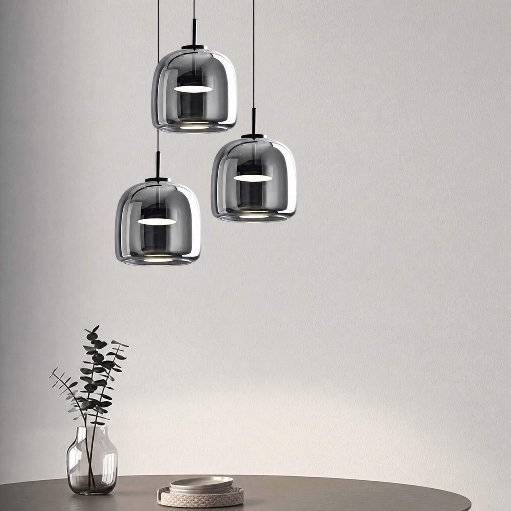 Moon glass pendant light set to cool white over a dining table