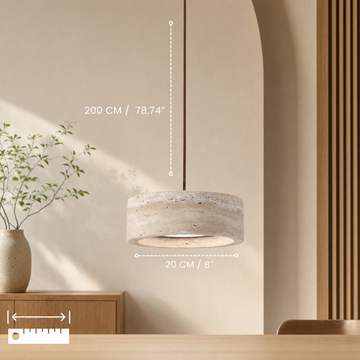 Travertine pendant light glowing warm in a cozy living room