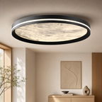Moon ceiling light glowing warm white in a modern bedroom