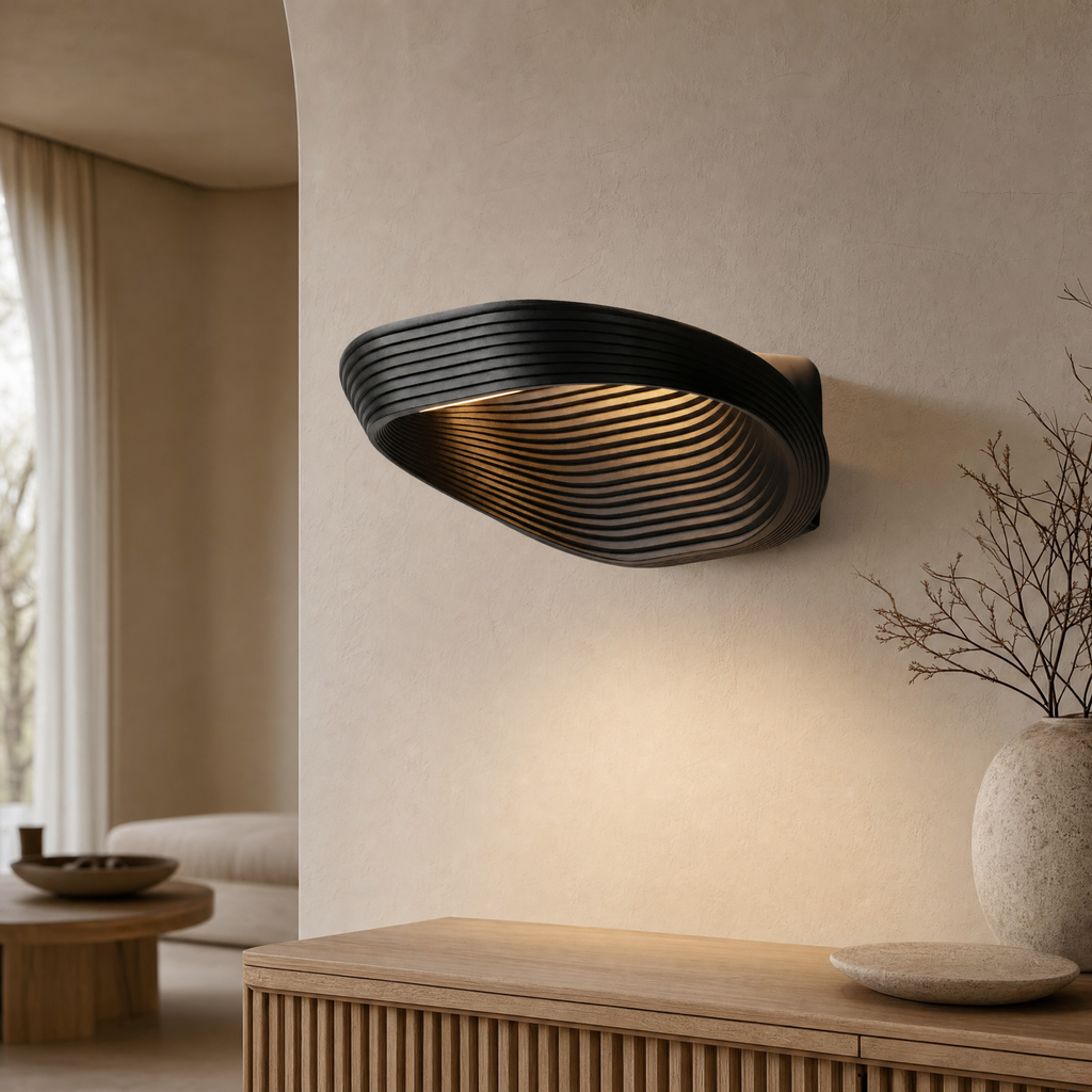 Geometric wall sconce glowing warm white in a modern bedroom