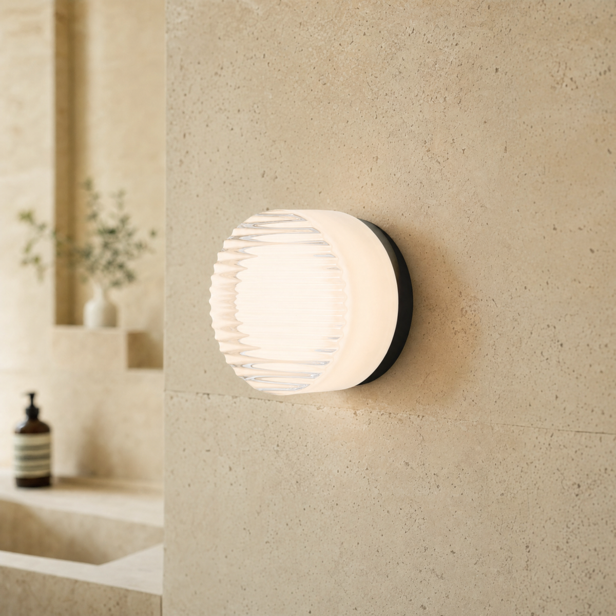 Vela modular wall sconce in White Ribbed on a travertine bathroom wall, spa atmosphere